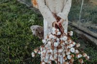 Kaboompics - A beautiful tall woman holds cotton branches