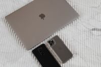 Kaboompics - Silver Laptop with Two Smartphones on White Ribbed Marble, Minimal Tech Flat Lay