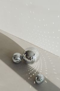 Kaboompics - Two Disco Balls Casting Diagonal Reflections on a Pale Wall