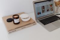 Kaboompics - Laptop, Lit Candle and Books on a Minimal White Desk