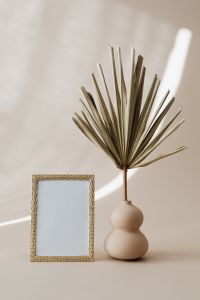 Kaboompics - Gold Textured Mini Picture Frame and Dried Palm in a Ceramic Vase, Beige Interior Mockup