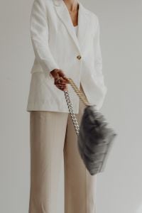 Kaboompics - Motion Blur of Gray Quilted Handbag Against a Neutral Pantsuit