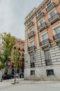 Kaboompics - Vertical Madrid Corner Facade with Brick, Stone Trim and Ornate Balconies