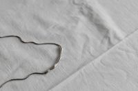 Kaboompics - Silver Chain Necklace on White Tablecloth
