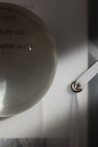 Kaboompics - Moody Close Up of Glass Paperweight and Elastic Document Folder