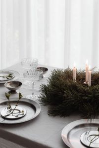 Kaboompics - Close Up White Christmas Table with Crystal Coupes, Silver Bowls and Decorative Branch