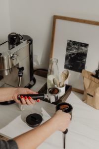 Kaboompics - Hands Filling a Portafilter with Ground Coffee