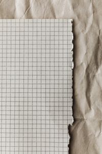 Kaboompics - Torn Grid Paper Vertical Mockup On Kraft