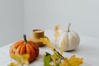 Kaboompics - Orange Pumpkin White Pumpkin and Candle on a White Table