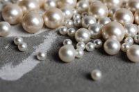 Kaboompics - Pearl Beads Along the Edge of Gray Concrete with Soft-Focus Copy Space