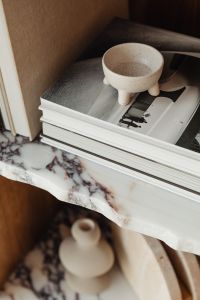 Kaboompics - Top-Down Styling of Photo Books and a Ceramic Bowl on a Marble Bookcase
