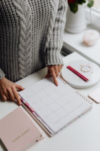 Kaboompics - Hand Writing in a Monthly Calendar with a Pink Pen