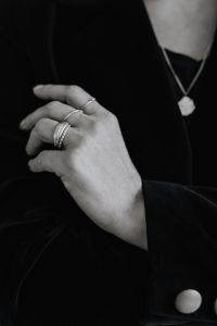 Kaboompics - Monochrome Woman Holding Pendant Necklace and Wearing Rings
