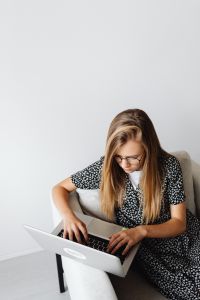 Kaboompics - Teenage Girl Studying on Laptop in Armchair with Copy Space