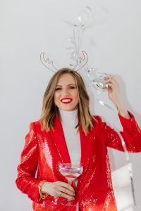 Kaboompics - Smiling Woman in a Red Sequin Suit with Champagne and Antler Headband, New Year's Eve Portrait