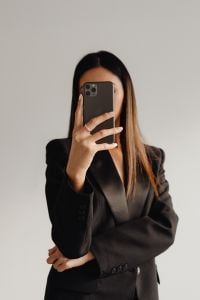 Kaboompics - Woman Using a Smartphone in a Tailored Black Suit