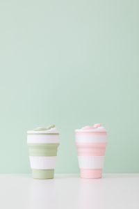 Kaboompics - Two Pastel Reusable Mugs in Portrait Layout with Copy Space
