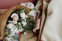 Kaboompics - Pastel Flower Bouquet Wrapped in Brown Paper beside a Cafe Sofa