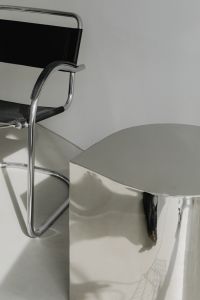Kaboompics - Chrome Armchair Beside Reflective Chrome Pedestal