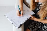 Kaboompics - Hand Writing Homework in Spiral Notebook