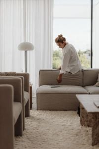 Kaboompics - Woman Relaxing on a Neutral Sofa by the Window