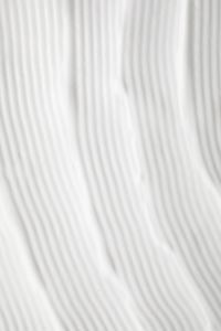 Kaboompics - Vertical Parallel Ridges in Smooth White Cream, Minimal Skincare Texture