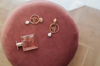 Kaboompics - Jewellery & pink perfume on Pouf