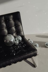 Kaboompics - Black Leather Lounge Chair with Disco Balls and Party Light Reflections