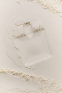 Kaboompics - Angled Fragrance Bottle Imprint on Flour Background