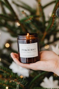 Kaboompics - Amber Glass Candle with Christmas Tree and Paper Ornaments