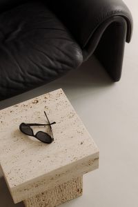 Kaboompics - Close-Up of Black Leather De Sede Sofa and Sunglasses on Travertine