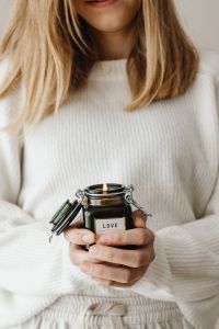 Kaboompics - Woman Holding Love Candle and Black Paper Ornaments