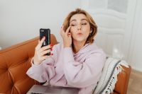 Kaboompics - Middle-Aged Woman on a Smartphone Video Call While Working from Home