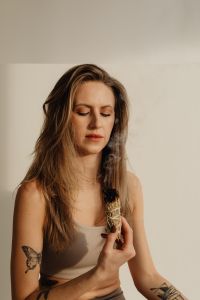 Kaboompics - Close-Up of Crossed Legs and Smoldering Sage in a Shell