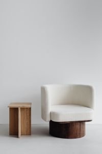 Kaboompics - Contemporary Bouclé Armchair and Wooden Side Table in a Neutral Living Room