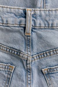 Kaboompics - Vertical Back Belt Loop and Waistband Seams on Light Wash Jeans, Close-Up