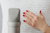 Kaboompics - Close-Up Hand on Textured White Pillow beside Microphone, ASMR Sound Trigger