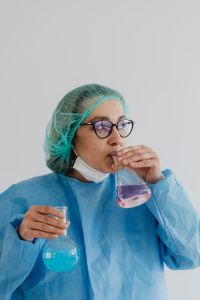 Kaboompics - Female Lab Technician Holding Glass Flask With Copy Space