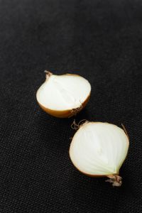 Kaboompics - Halved Onions on a Black Background