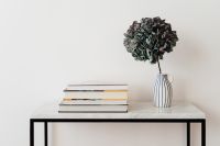 Kaboompics - Books and Hydrangea Vase Styled on a White Marble Console Table