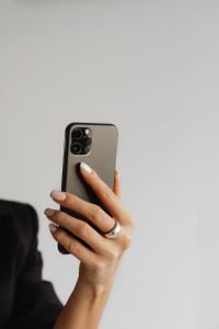 Kaboompics - Smartphone with Wired Earphones in a Woman's Hand