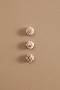 Kaboompics - Three Speckled Scored Tablets on a Beige Background