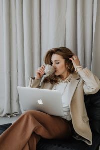 Kaboompics - Businesswoman with Coffee and Laptop in a Neutral Office