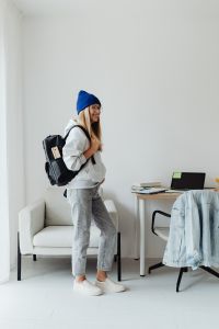Kaboompics - Teenage Student with Backpack in Blue Beanie at Home