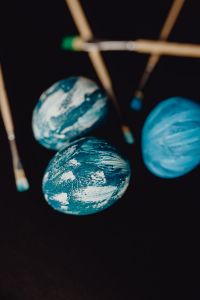 Kaboompics - Woman Painting Blue Easter Eggs