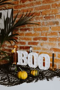 Kaboompics - Halloween BOO Letters, Pumpkins and Plant Against Brick Wall