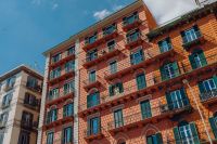 Kaboompics - Tall Coral Tenement Facade With Green Shutters in Naples
