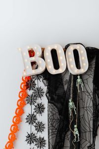 Kaboompics - Halloween BOO Sign with Spiderwebs and Hanging Skeletons