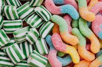 Kaboompics - Striped Candy and Colorful Gummy Worms, Overhead Sweet Treat Flat Lay