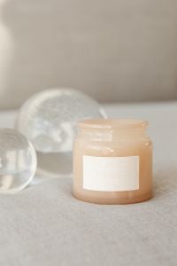 Kaboompics - Amber Candle Jar Mockup with Blank Label and Glass Orbs